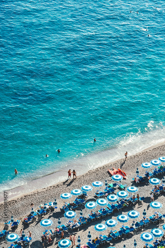 Blue beach umbrellas and the beautiful shoreline of the beach at Positano on the Amalfi Coast. photo