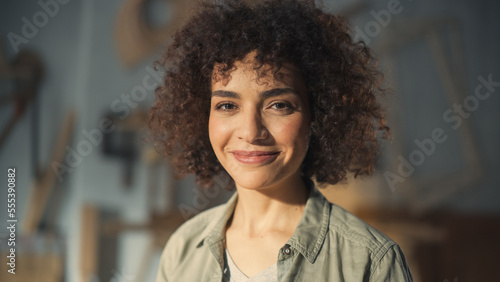 Close Up Portrait of a Beautiful Female Creative Specialist with Curly Hair Smiling. Young Successful Multiethnic Arab Woman Working in Art Studio. Dreaming About Better Life and Opportunities Ahead.
