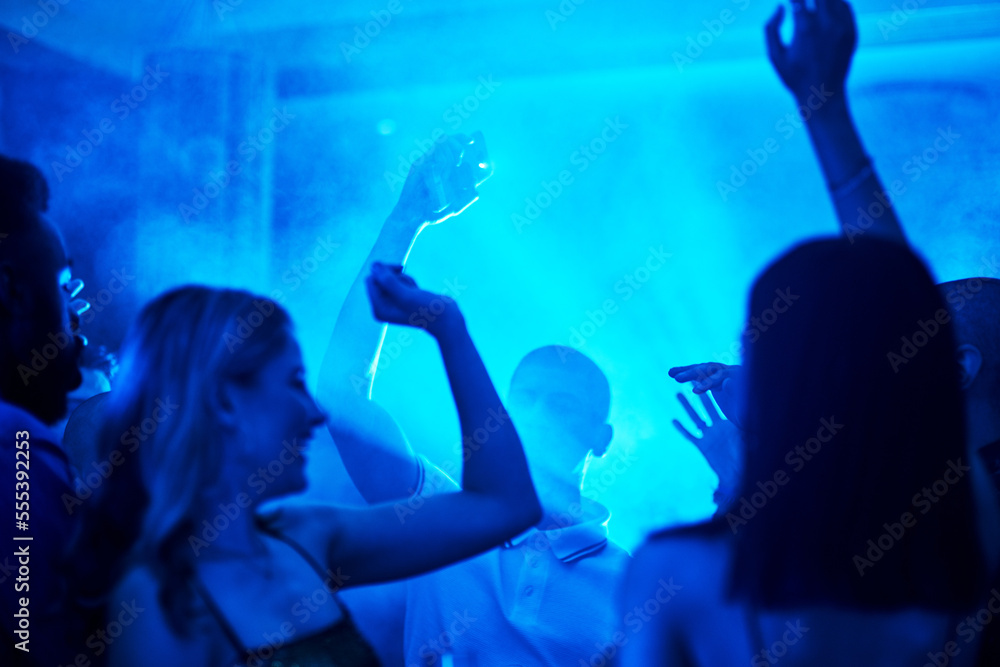 People dancing in a nightclub, crowd at a party listening to disco or social celebration of new years eve in Las Vegas. Music festival event, celebrate a night out together or techno lighting at rave
