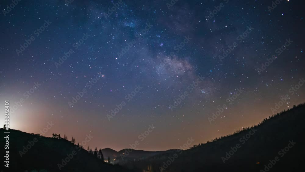 Starry sky timelapse at night in California. Milky way is visible in darkness Starry sky timelapse at night in California. Milky way is visible in darkness