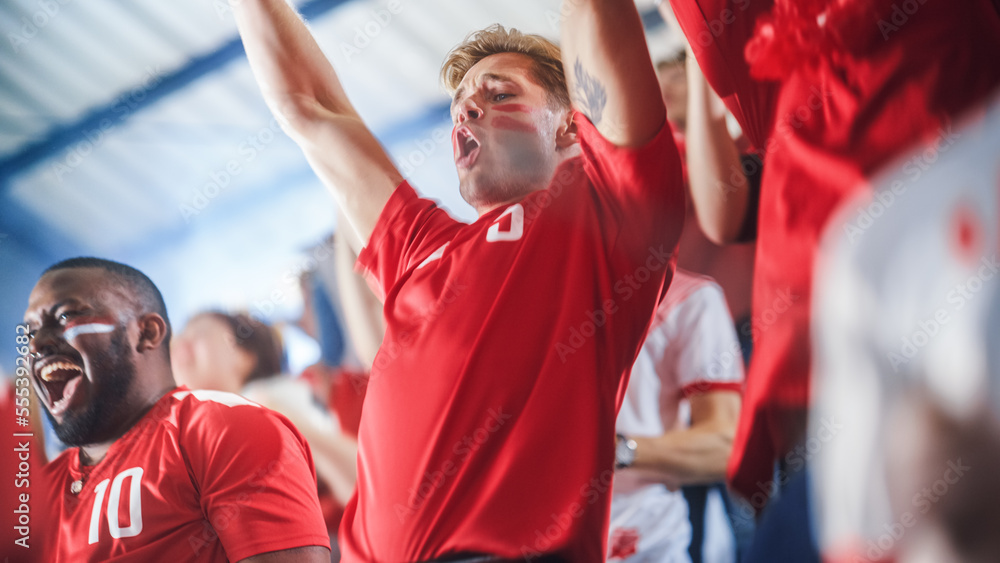Fototapeta premium Sport Stadium Sport Event: Intense Caucasian Man Cheering, Whistling. Crowd of Fans with Painted Faces Stand up, Cheer, Shout for Red Soccer Team to Win, Celebrate Scoring Goal, Championship Victory