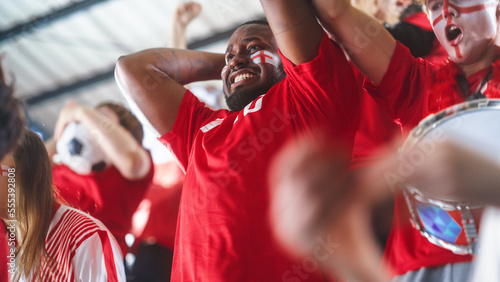 Sport Stadium Sport Event: Close-up Portrait of Handsome Black Man with Painted Cheering for Red Team to Win, Screaming in Celebration of a Victory. International Championship, World Tournament Cup