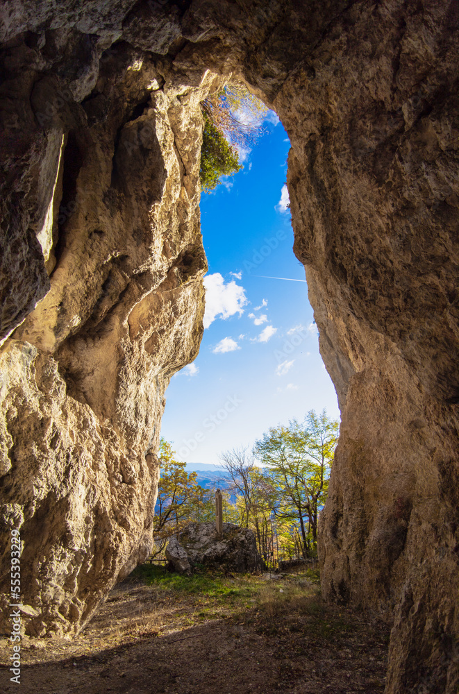 Monte La Serra (Italy) - The peak of Monti del Cicolano beside Rieti and Salto lake, during the autumn foliage, with the hikers and sanctuary cave named Grotta di Santa Filippa.