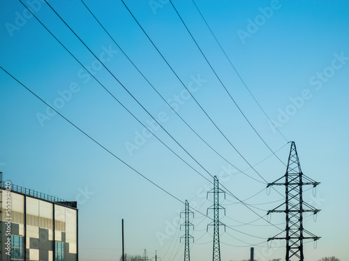 High voltage electricity power line towers against the sky. Transmission towers