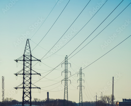 High voltage electricity power line towers against the sky.  Transmission towers