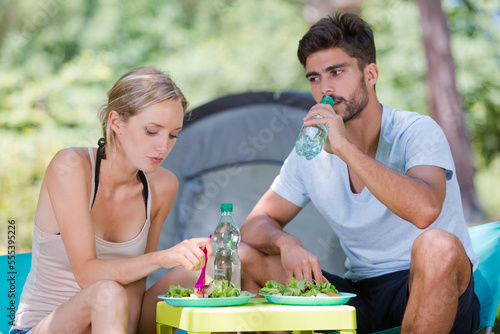 cute couple sharing lunch outdoors