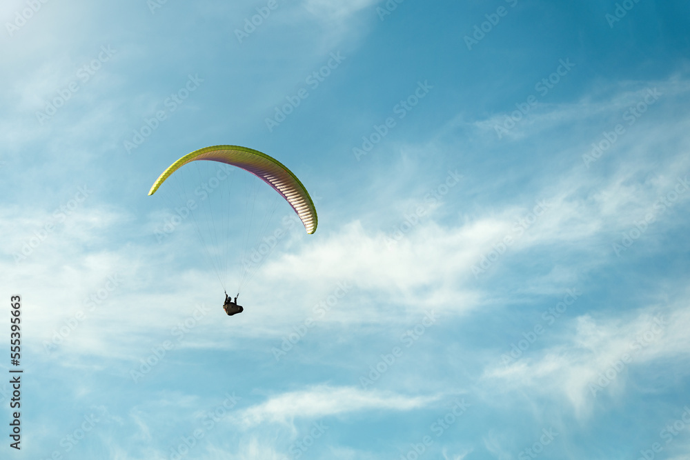 Paraglider flying among epic sky on a sunny day Paraglider flying among epic sky on a sunny day