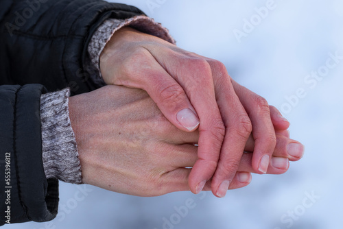 Frozen women's hands.The girl is trying to warm her frozen in the cold hands.Care for the skin of the hands in the winter.