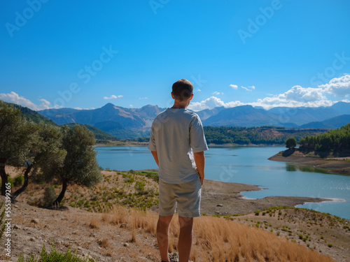 Tourist look at lake and mountains Karacaoren lake and mountains landscape, mediterranean area on warm summer day st. Peter trail. concept of Zero waste travel, active lifestyle, summer vacation