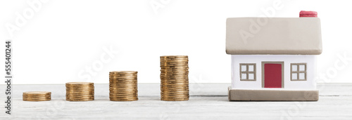 House Model and Golden Coins Stacks on the desk