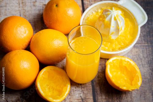 freshly squeezed orange juice in a glass on a wooden background