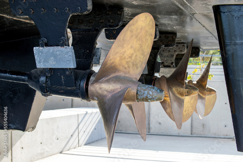 ship propeller, made of yellow metal.