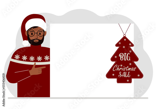 A man near a large white sheet of paper with a big sale label on it. New Year and Christmas sales.