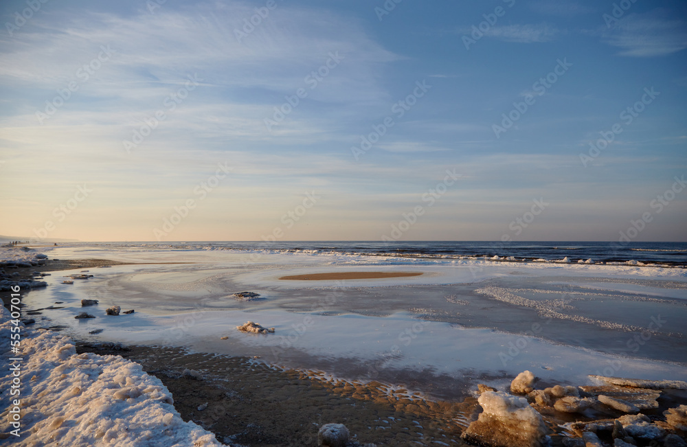 Winter view on the icy sea coast and beautiful calm sky, selective focus Winter view on the icy sea coast and beautiful calm sky, selective focus