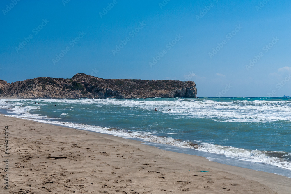Coast of Mediterranean Sea. Turquoise foamy waves. Sand beach. Close-up. Sunny autumn day. Fethiye, Turkey.