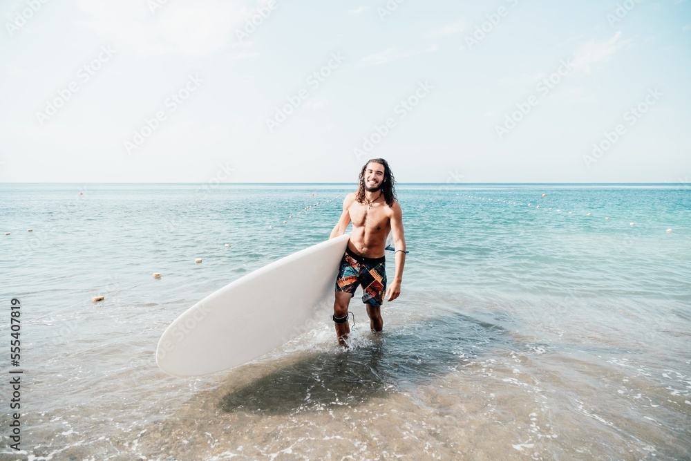 Fototapeta premium Sea man sup. Asian athlete man swimming in sea and paddleboarding at summer sunset. Healthy strong male enjoy outdoor active lifestyle and water sports on holiday vacation. Slow motion