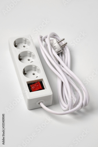 White extension cord for three sockets witn illuminated power circuit breaker