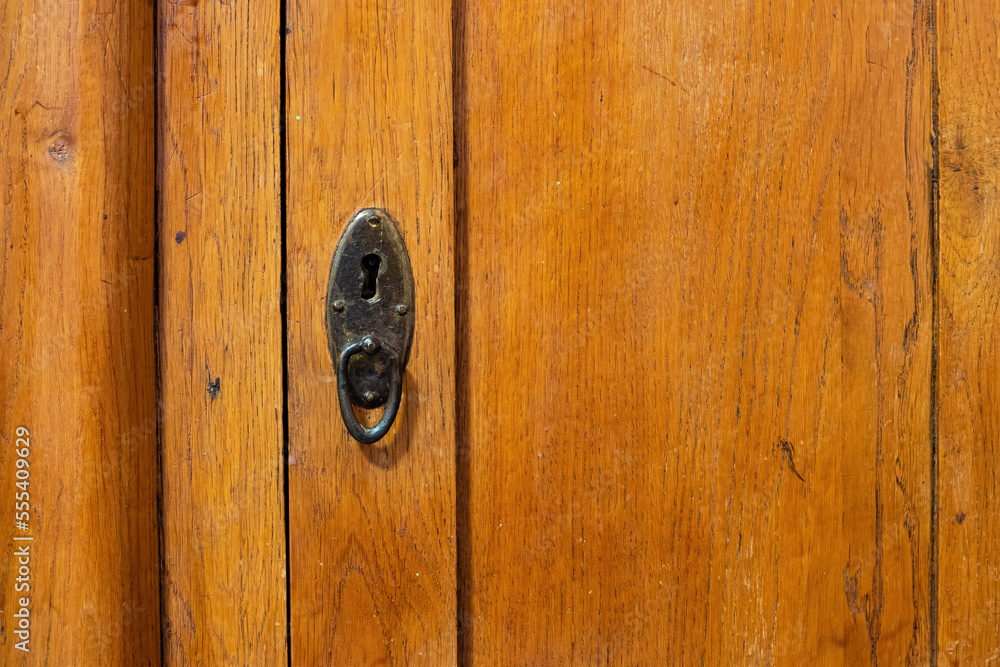 Lock and handle in the door of an old wooden cabinet Keyhole close up Lock and handle in the door of an old wooden cabinet Keyhole close up
