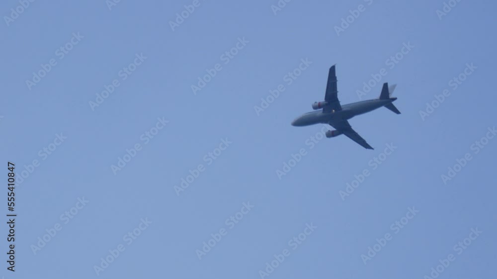 Modern airplane flying in blue sky, Low Angle View, airplane landing in bright sky Modern airplane flying in blue sky, Low Angle View, airplane landing in bright sky