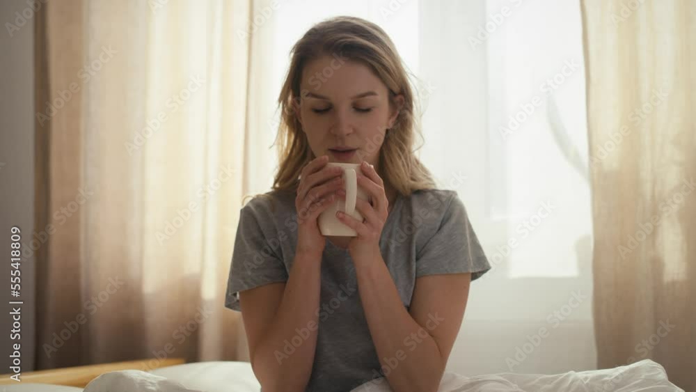 Caucasian woman drinking coffee at morning in bed. Shot with RED helium camera in 8K. Caucasian woman drinking coffee at morning in bed. Shot with RED helium camera in 8K.