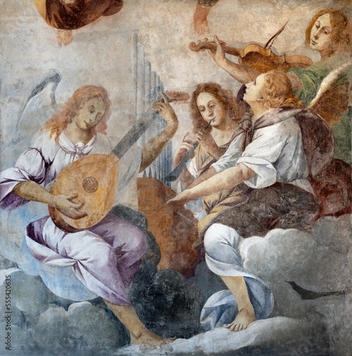 DOMODOSSOLA, ITALY - JULY 19, 2022: The baroque fresco of angels with the music instruments in the church Chiesa dei Santi Gervasio e Protasio by Lorenzo Peretti (1774 – 1851). photo