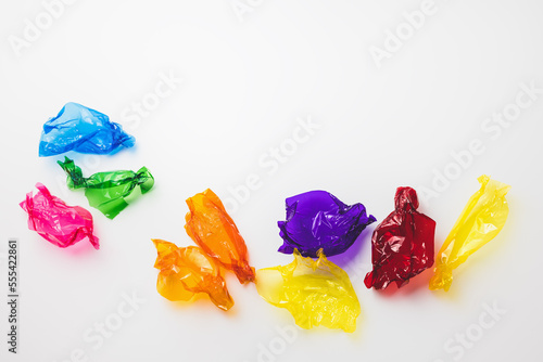 Colorful candy wrappers on white background, copy space photo