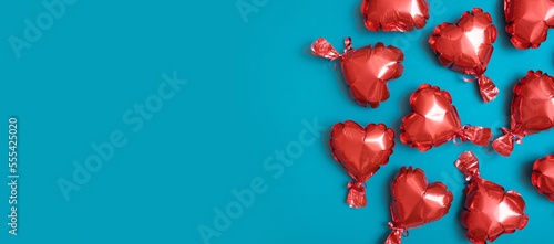 Banner with red heart shape baloons on turquoise background. Valentines Day concept