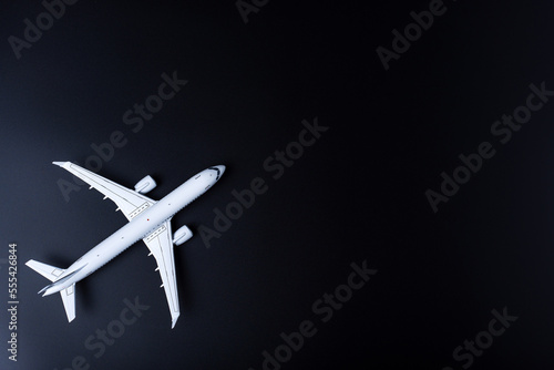 The passenger plane on black background with empty space for text. Top view, copy space
