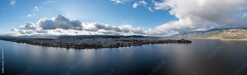 Greece, Ioannina  city. Aerial view panorama of Giannena and Lake Pamvotis, cloudy blue sky.