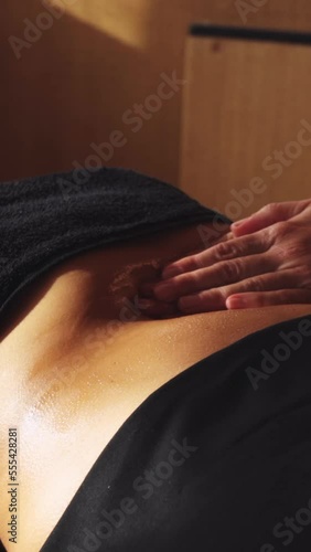 hands and arms of unrecognizable person massaging the belly of a patient, Ayurveda treatment, vertical video, HD