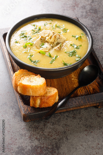 Εκτύπωση καμβά Creamy artichoke puree soup served with toasted bread close-up in a bowl on the table