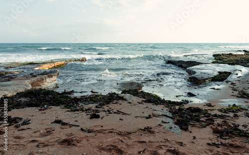 Waving sea near sandy beach photo