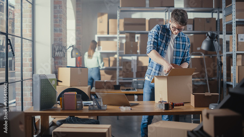 Inventory Manager Packaging a Stylish Bicycle Seat Sold to a Client Online. Preparing a Small Cardboard Parcel for Postage. Young Small Business Owner Working in Warehouse.