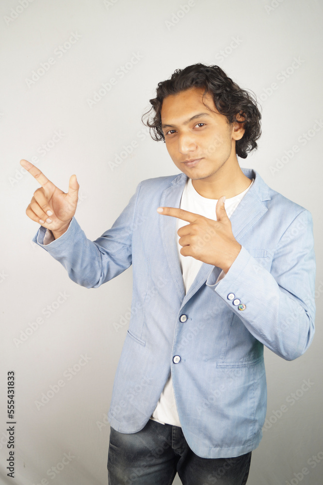 Confident businessman showing index finger over white background Confident businessman showing index finger over white background