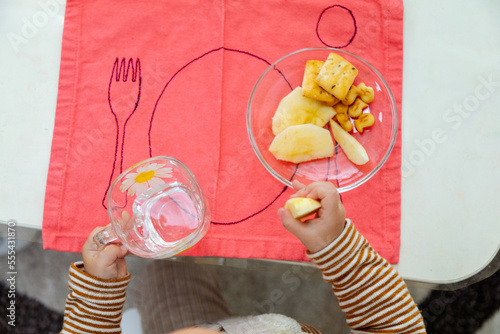 Top view toddler eating by the table photo