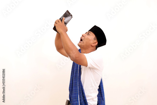 Poor and depressed Asian man wear gray shirt. Isolated on white background. Concept of desperate life. photo