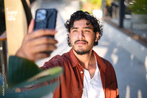 Smiling man taking a selfie with his mobile phone photo