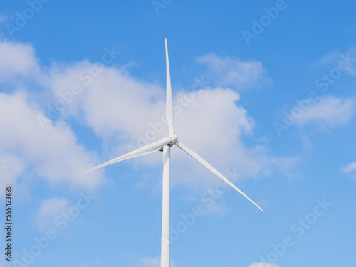Close-up of Wind electric generator. Wind generators stand in agricultural fields with Powerful wind turbine farms for pure energy production on the background. 