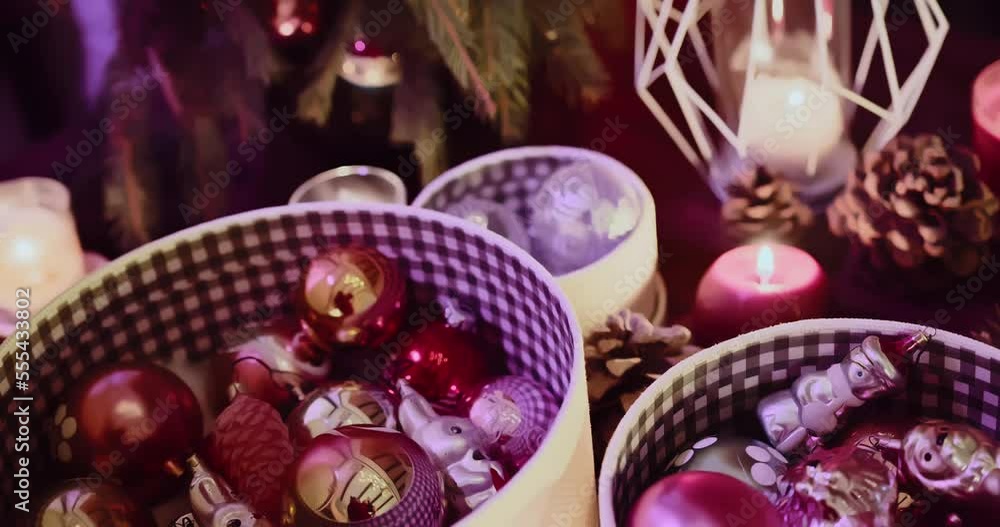 Close-up of Christmas decorations in a box. A woman's hand takes Christmas balls Close-up of Christmas decorations in a box. A woman's hand takes Christmas balls