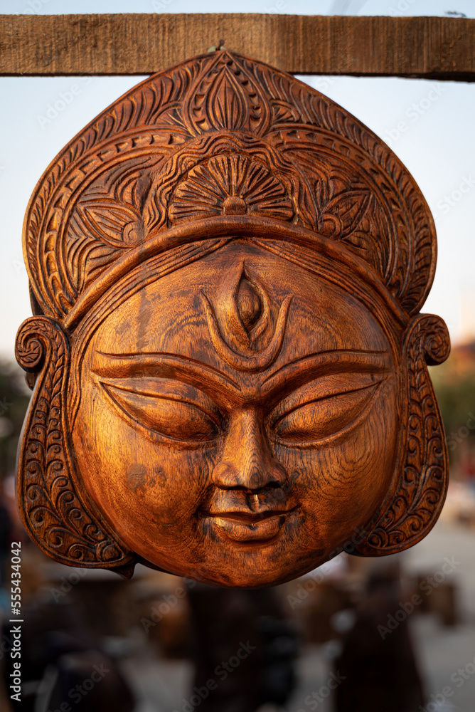 Beautiful handmade wooden sculpture of Goddess devi Durga is displayed in a shop for sale in blurred background. Indian art and handicraft. Beautiful handmade wooden sculpture of Goddess devi Durga is displayed in a shop for sale in blurred background. Indian art and handicraft.