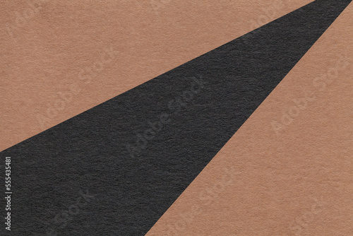 Texture of old craft brown and black color paper background, macro. Structure of vintage abstract umber cardboard