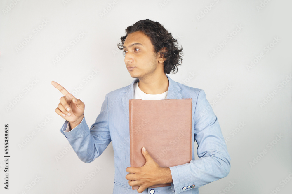 Handsome businessman pointing away while standing over white background Handsome businessman pointing away while standing over white background