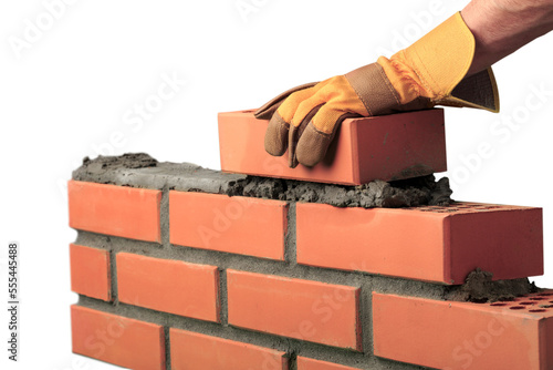 Obraz na płótnie Man worker installing brick masonry wall with a trowel
