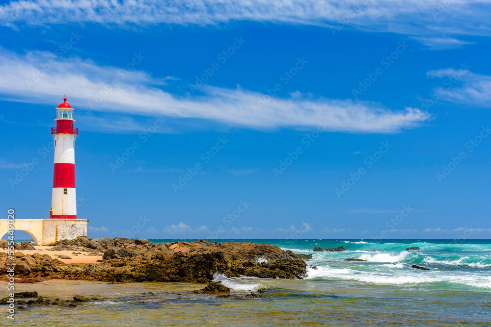 Colorful lighthouse on the sands of the famous Itapua beach in the city of Salvador in Bahia