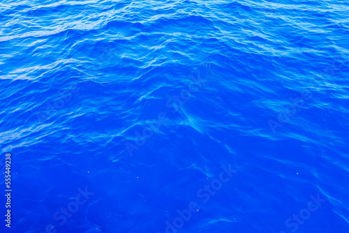 Very nice sea water background or backdrop with selective focus. Small waves of natural water surface texture.