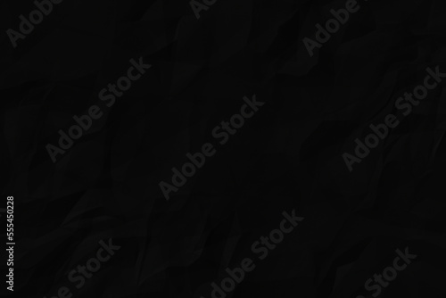 Black crumpled paper texture background. A crumpled sheet of dark gray paper abstract background. 