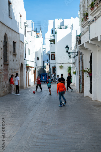 A group of boys and girls playing soccer together in the street of Tanger, Morocco