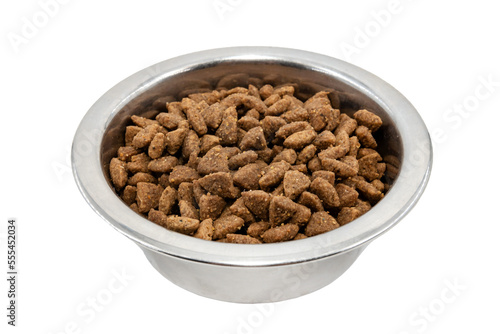 Dry dog ​​food in a metal plate on a white background top view. Feed