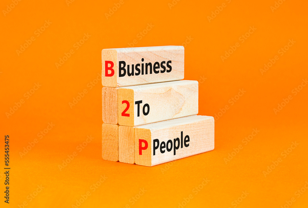 Naklejka premium B2P business to people symbol. Concept words B2P business to people on wooden blocks on a beautiful orange table orange background. Business and B2P business to people concept. Copy space.