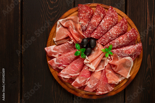 Assortment , sliced meat appetizer, prosciutto, salami and ham, with olives, breakfast, top view, close-up, no people,